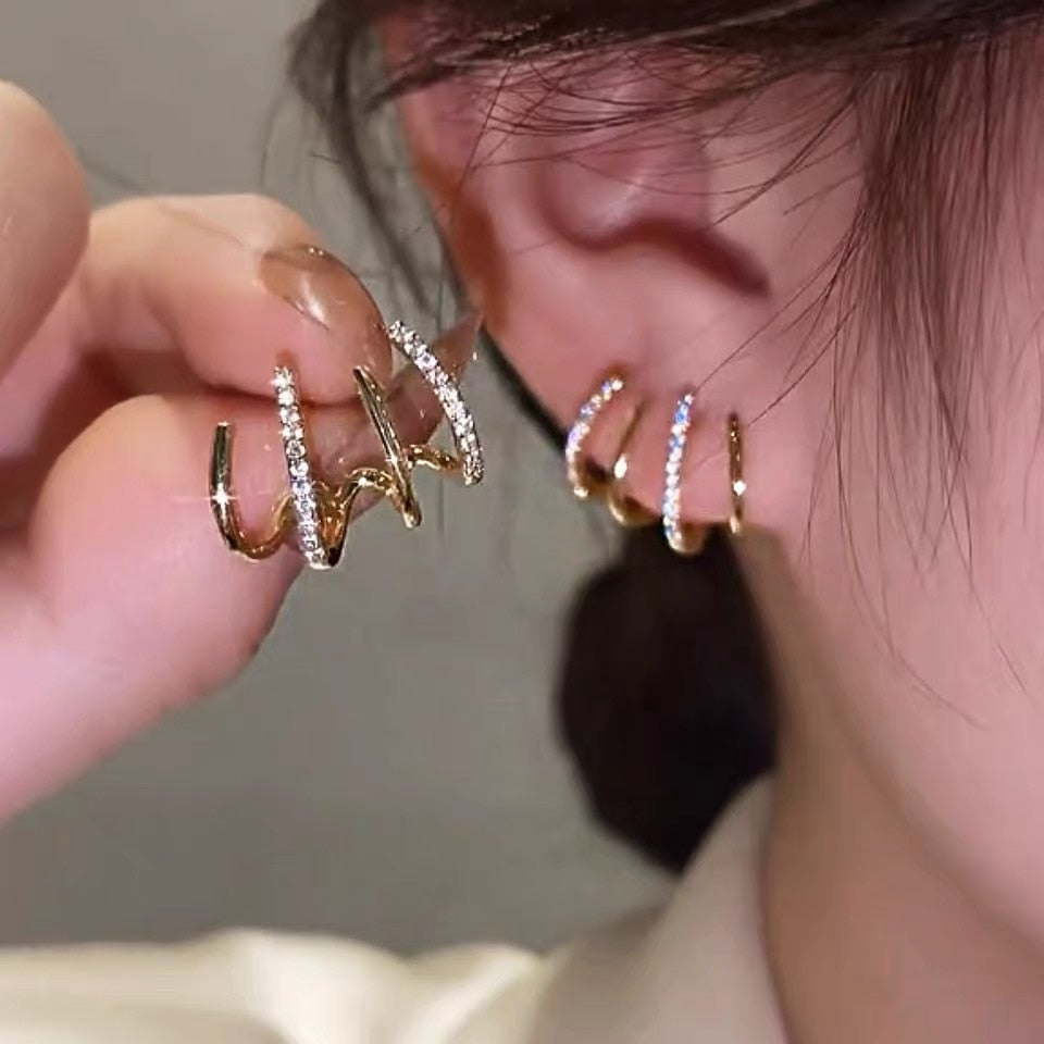 Brincos Ear Cuff cravejadas dourado